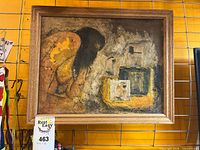 Full view of framed mixed media artwork on display