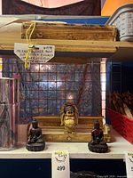 Shelf with wooden incense box, gold-tone face holder and two Buddha holders