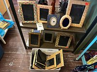 Two-shelf unit showing majority of Kashmir frames plus box of additional frames