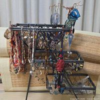 Full view of stand showing large assortment of jewelry hanging
