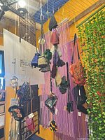 Overview of hanging handmade pouches, bags and hats