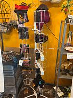Full rotating rack with wallets, pouches, incense boxes, hats visible
