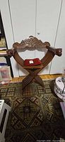 Full view of carved wooden Savonarola folding chair