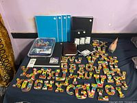 Full lot showing notebooks, sketchbooks, wooden letters, bird figurine, puzzle, boxed accessories