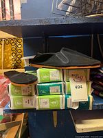 Stacked boxes with black slip-on shoes on top