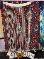 Overall lot view with tapestry backdrop, bead curtain, disco ball, sandals, packaged tapestries