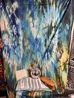 Full lot: hanging display tapestry (not included), eight packaged tapestries, door curtain, disco ball, sandals