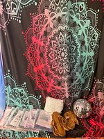 All items grouped: packaged tapestries, macramé curtain, sandals, disco ball, backdrop tapestry