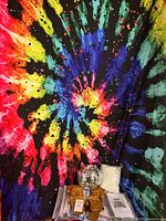 Overall lot: hanging tapestry backdrop, disco ball, sandals, packaged tapestries visible