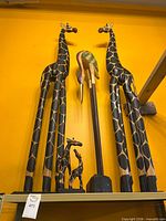 two tall giraffes, tall stork, two small giraffes front view