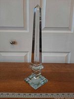 Front view of crystal obelisk on wooden surface