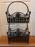 Front view of full two-tier wrought iron basket stand
