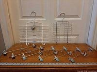 Overview of both tie racks and nine trouser hangers on table