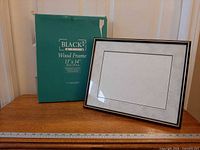 Frame alongside original retail sleeve showing branding and size