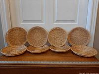 All eight wicker paper plate holders lined up in a row
