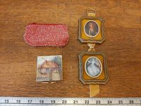 Overview of coin purse, pillbox, and double portrait frames on measuring surface