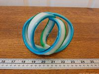 Front view of glass knot with ruler for scale