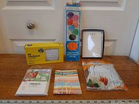 All items laid out: knives box, pom-poms pack, three invitation packs, spoons bag