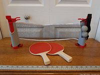 Full set showing net assembly, two paddles and two balls