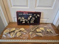 Both plaques in plastic sleeves with box behind, ruler for scale