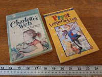 Both books side by side with ruler for scale