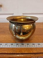 Front view brass planter with rope and tassels