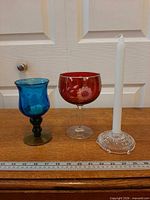 All three glass pieces with candle for scale