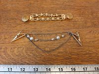 Overview of both sweater guards on ruler for scale