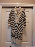 Full view of striped sweater dress hanging