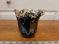 Front view of Murano fluted art glass vase next to ruler showing height