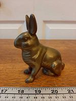 Brass rabbit coin bank side profile with ruler for length