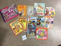 Photo of 13 children's books including Arthur series, LEGO themed books, and 'Just For Girls Truth or Dare' game box.