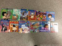 Top view of 12 children's books with colorful covers showing characters from Disney Junior, Olivia, Dora the Explorer, and others.