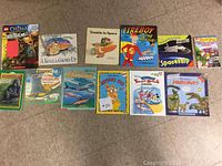 Collection of 13 children's books, colorful covers featuring animals, dinosaurs, space, and characters such as Fireboy and Arthur.
