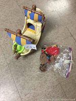 Top and side view of toy pirate ship showing detailed sails and deck accessories.