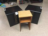 Three tables shown together: two black night tables and one smaller oak table in front