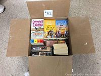 Box with multiple hardcover and paperback books by Stephen R. Lawhead, including The Pendragon Cycle.