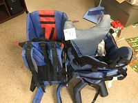 Two child carriers side by side showing seating and straps