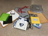 Photo of assorted office supplies including a phone fax machine, cork boards, wire shelves, and organizers.