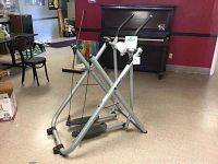 Silver Gazelle Freestyle exerciser elliptical-style machine with instruction DVD attached at front, shown assembled in room.