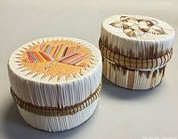 Two round quilled birch bark baskets with lids shown from top angle