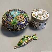 Group shot showing both trinket boxes and fish pendant