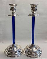 Front view of both candlesticks standing upright