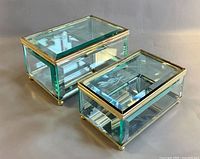 Two beveled glass brass trinket boxes, larger and smaller, front angle
