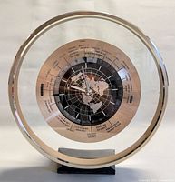 Front view showing full clock, acrylic frame, dial, base