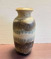 Full front view of tall drip-glaze ceramic vase