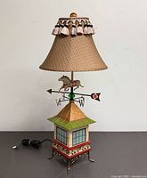 Front view of full lamp showing shade, weathervane horse, base, and power cord