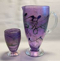 Pitcher and glass front view showing color and design