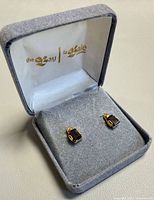 Pair of earrings inside grey La Baie box