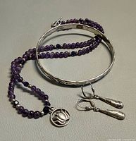 Overall view of bangle, amethyst necklace and earrings